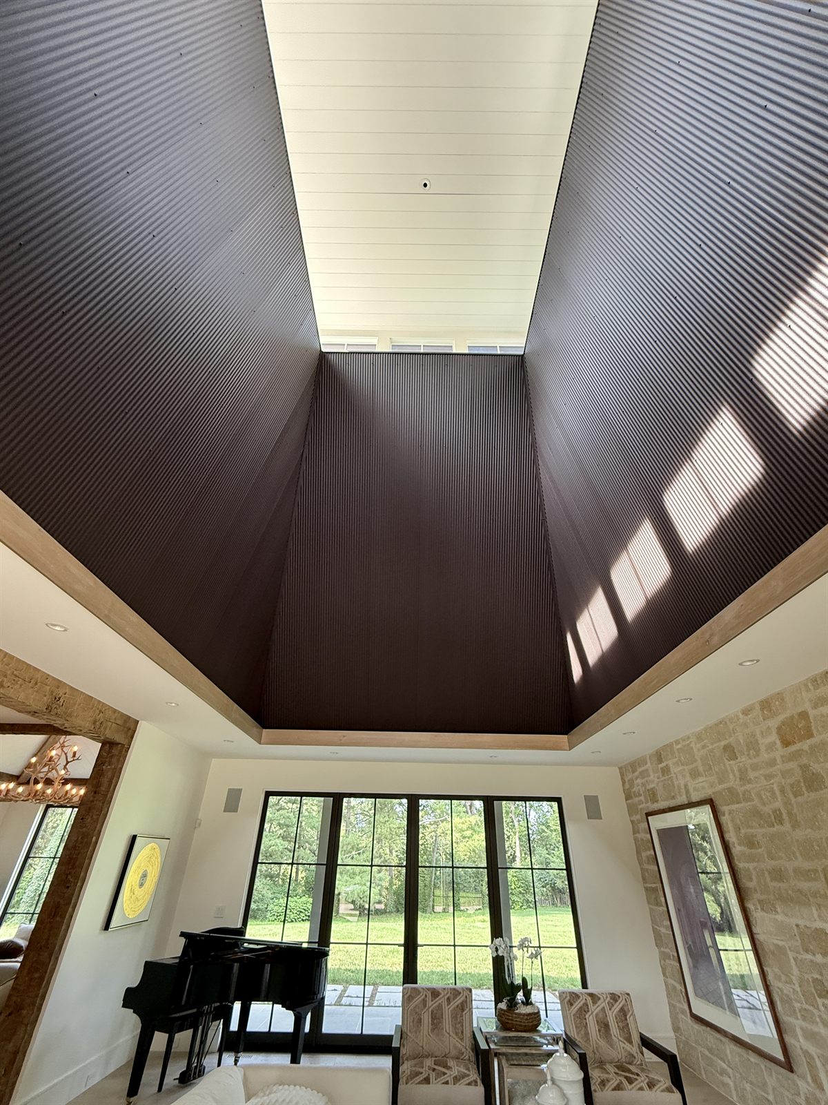 Vaulted tower ceiling with clerestory windows and steel-look doors