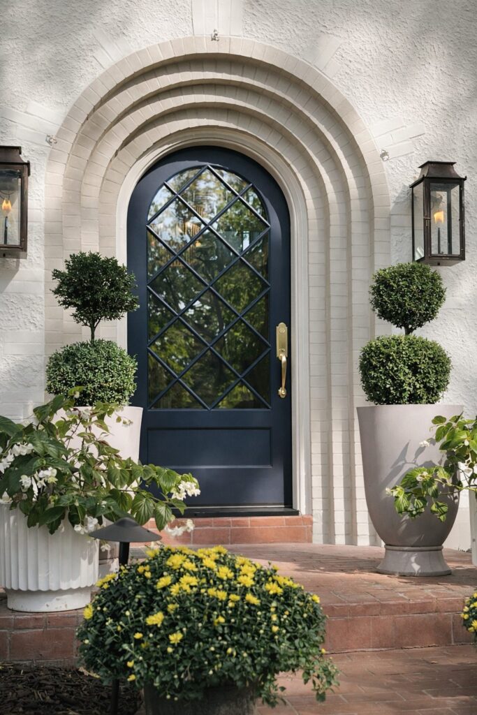 Navy arched entry door with diamond lites